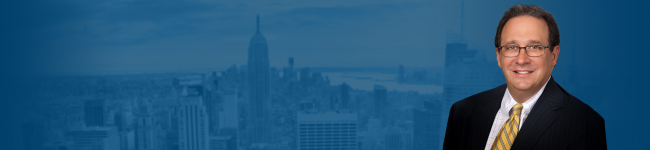 Stephen Bilkis against a blue-tinted cityscape background featuring the Empire State Building.